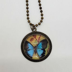 Blue Butterfly Pendant in Antique Brass